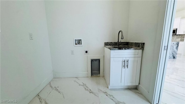 washroom with marble finish floor, hookup for an electric dryer, washer hookup, and a sink