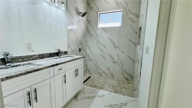 full bathroom featuring a sink, a marble finish shower, marble finish floor, and double vanity