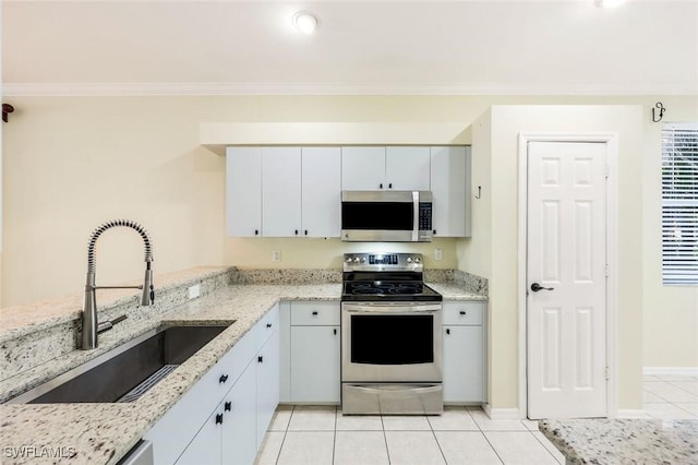 1963 Morning Sun Ln Unit F36, Naples, FL 34119 - kitchen with light stone counters, light tile patterned flooring, a sink, appliances with stainless steel finishes, and crown molding