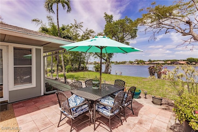 view of patio / terrace with outdoor dining space and a water view