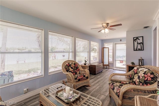 sunroom with a ceiling fan and visible vents