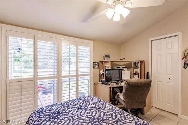 tiled bedroom with a ceiling fan and vaulted ceiling