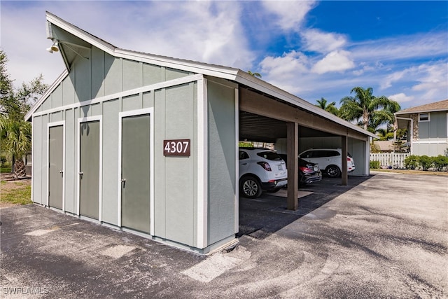 exterior space featuring covered parking and fence