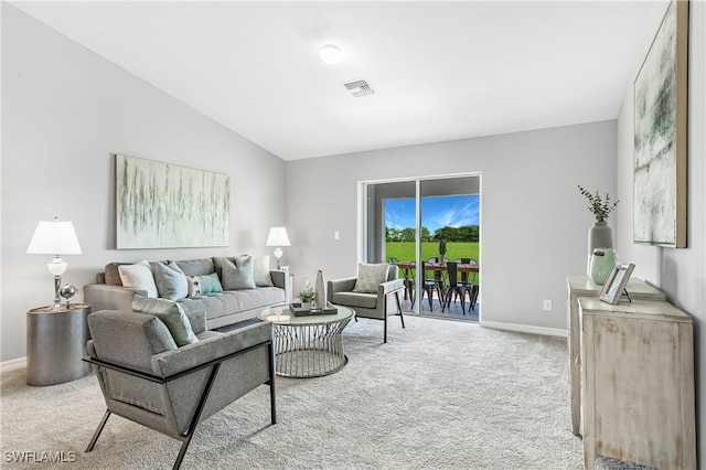 carpeted living area with visible vents, baseboards, and vaulted ceiling