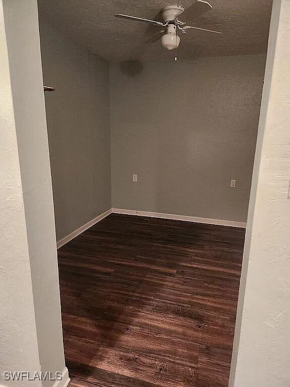 1280 Mcneill Rd, North Fort Myers, FL 33903 - unfurnished room featuring baseboards, ceiling fan, and dark wood finished floors