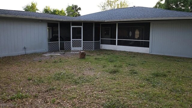 1280 Mcneill Rd, North Fort Myers, FL 33903 - back of house featuring a yard, a sunroom, and a shingled roof