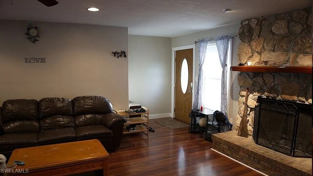 1280 Mcneill Rd, North Fort Myers, FL 33903 - living room featuring baseboards, a stone fireplace, and wood finished floors