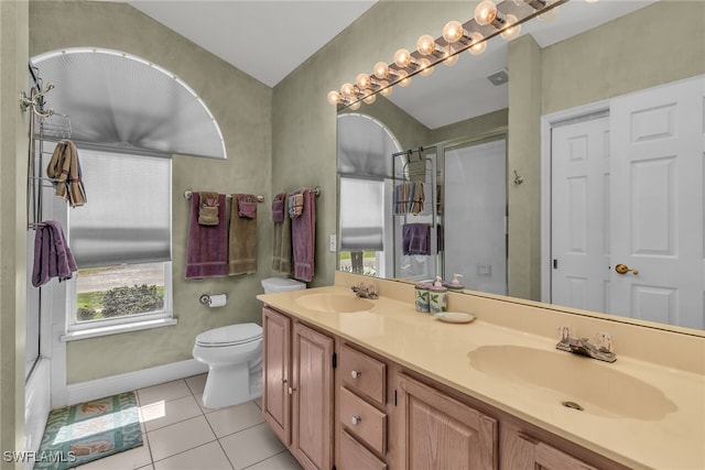 full bathroom featuring tile patterned flooring, double vanity, toilet, and a sink