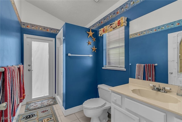 bathroom featuring toilet, a textured ceiling, a shower stall, tile patterned flooring, and vanity