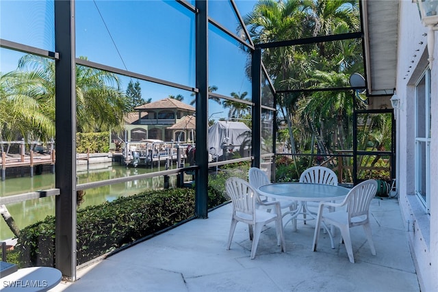 unfurnished sunroom featuring a water view