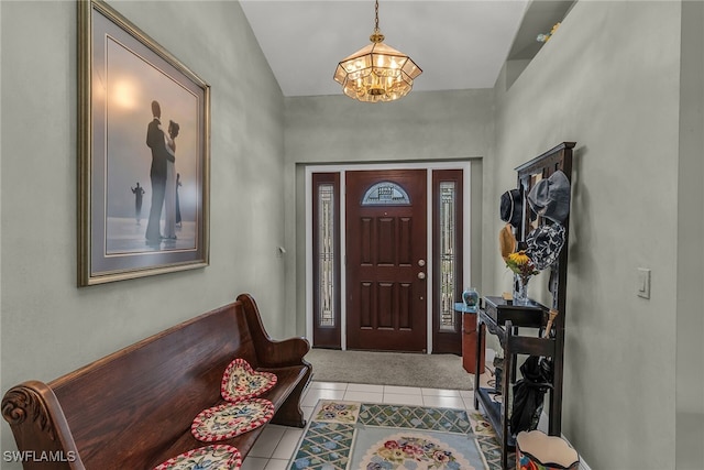 foyer with a chandelier and tile patterned flooring