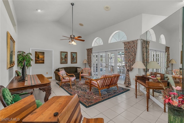 living area with high vaulted ceiling, light tile patterned floors, french doors, and ceiling fan