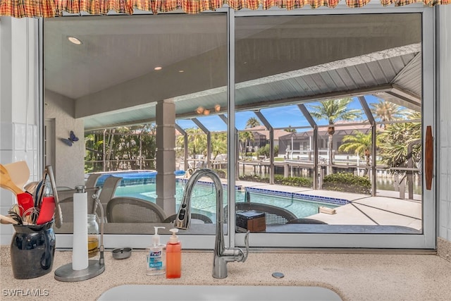 exterior space featuring a sink, a lanai, a jacuzzi, and a patio