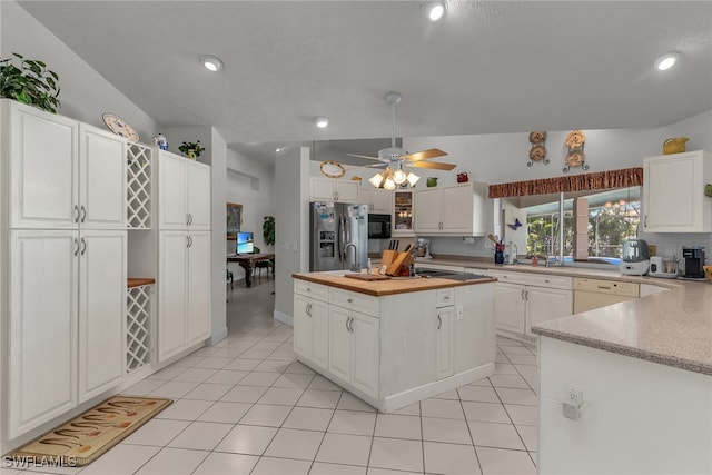 kitchen with white cabinets, light tile patterned flooring, stainless steel refrigerator with ice dispenser, and butcher block countertops