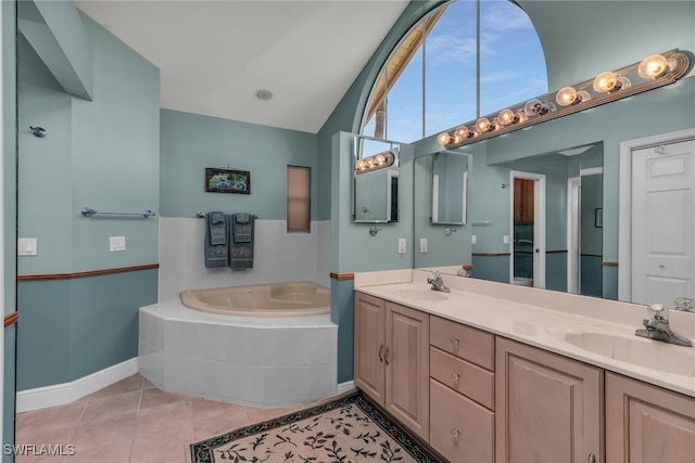 bathroom with tile patterned floors, a bath, vaulted ceiling, and a sink