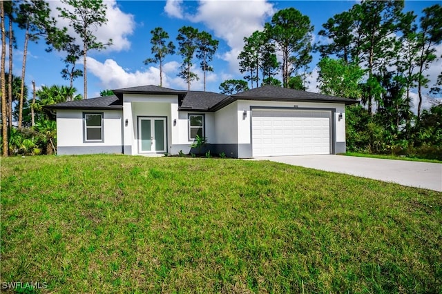 view of front of house featuring stucco siding, driveway, french doors, a front yard, and a garage