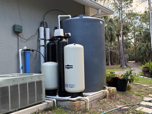 exterior details with cooling unit and stucco siding