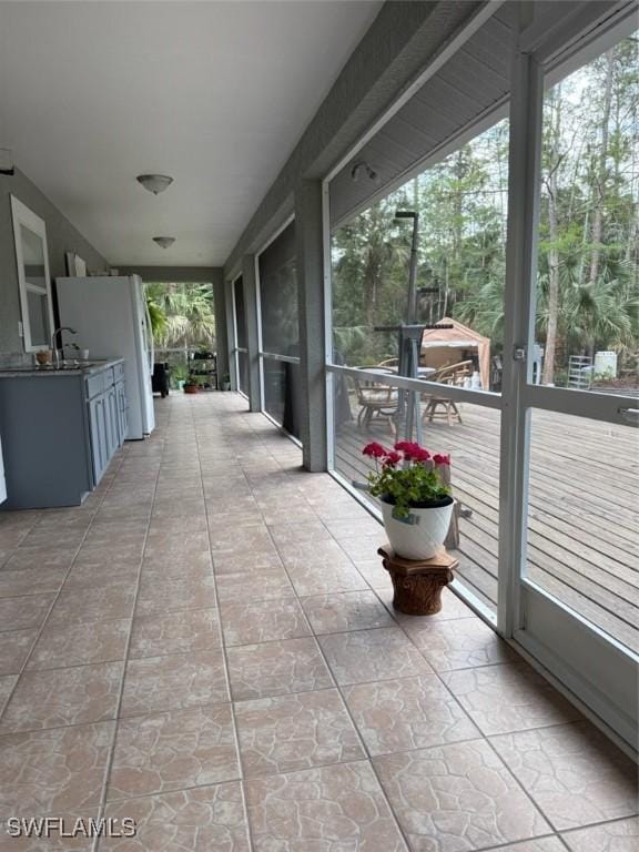 view of patio featuring a balcony and a sink