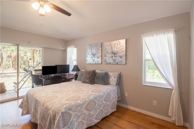 420 20th Ave NW, Naples, FL 34120 - bedroom with access to outside, wood finished floors, baseboards, and a ceiling fan