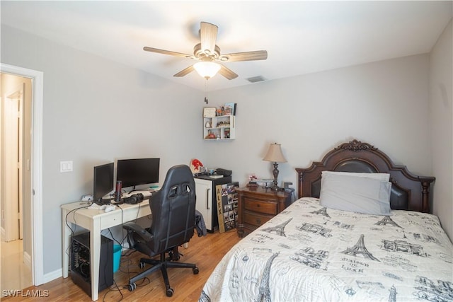420 20th Ave NW, Naples, FL 34120 - bedroom featuring wood finished floors, an office area, a ceiling fan, and baseboards