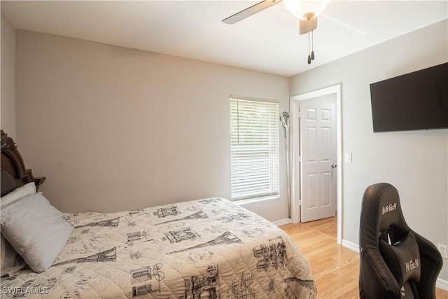 420 20th Ave NW, Naples, FL 34120 - bedroom with light wood-style flooring, baseboards, and a ceiling fan