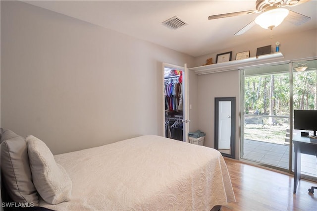 420 20th Ave NW, Naples, FL 34120 - bedroom featuring access to outside, light wood-type flooring, a walk in closet, a closet, and ceiling fan