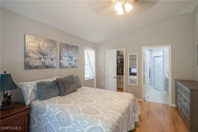420 20th Ave NW, Naples, FL 34120 - bedroom featuring light wood-style floors, vaulted ceiling, a spacious closet, ensuite bathroom, and a closet
