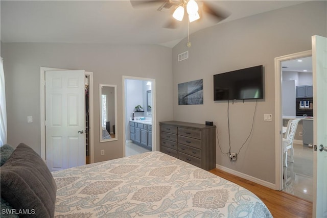 420 20th Ave NW, Naples, FL 34120 - bedroom featuring vaulted ceiling, wood finished floors, baseboards, ensuite bath, and ceiling fan