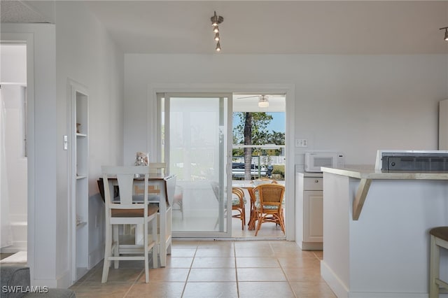 125 Palmetto Cir NE, Port Charlotte, FL 33952 - dining space with light tile patterned floors and built in features
