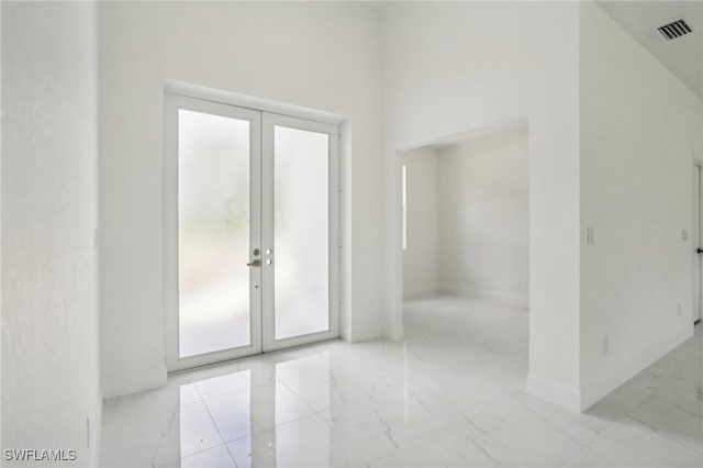 unfurnished room with french doors, visible vents, marble finish floor, and baseboards