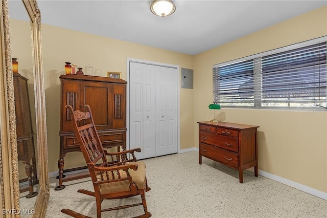 living area with electric panel and baseboards