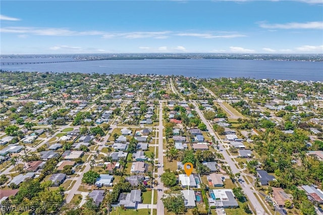 drone / aerial view featuring a residential view and a water view