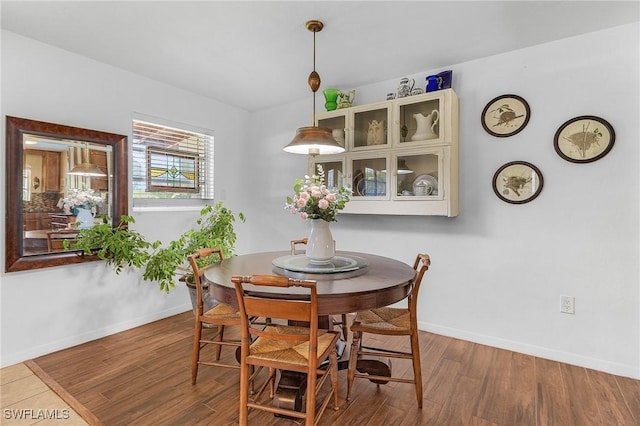 dining room with baseboards and wood finished floors