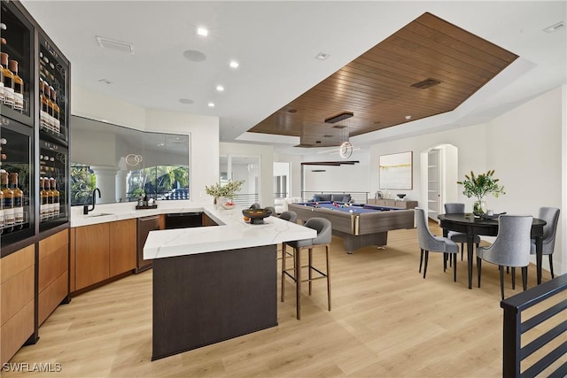 4831 Conover Ct, Fort Myers, FL 33908 - kitchen with wooden ceiling, a sink, a breakfast bar, visible vents, and light wood-style floors