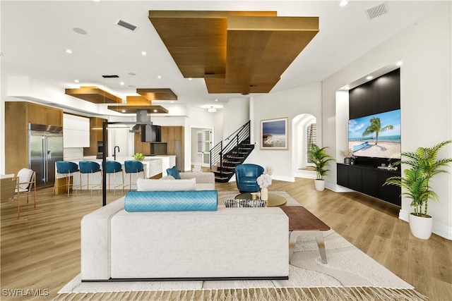 4831 Conover Ct, Fort Myers, FL 33908 - living room featuring stairs, visible vents, and light wood-type flooring