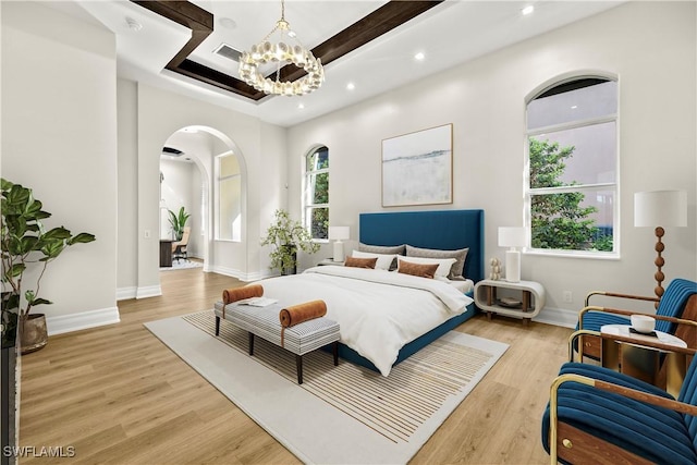 4831 Conover Ct, Fort Myers, FL 33908 - bedroom featuring arched walkways, visible vents, light wood-type flooring, and a notable chandelier