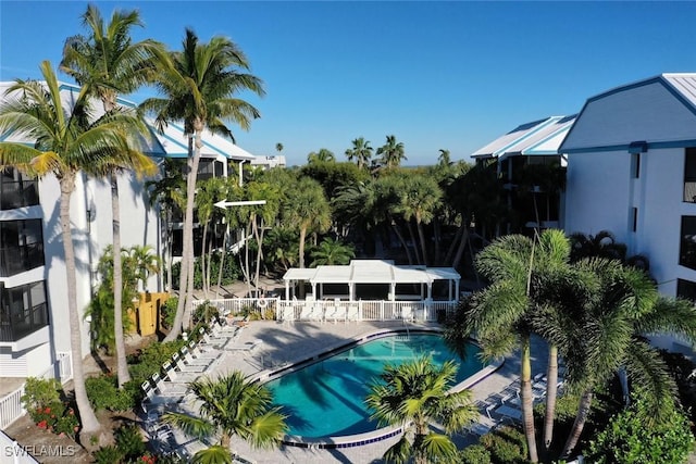 pool featuring a patio, fence, and a pergola