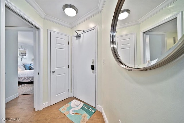 interior space with baseboards, light wood-style floors, and ornamental molding