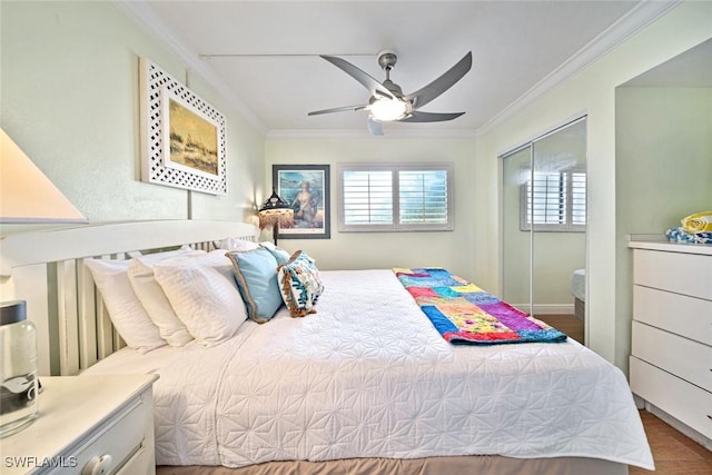 bedroom featuring a closet, wood finished floors, ornamental molding, and a ceiling fan