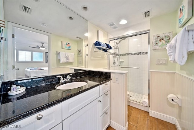 ensuite bathroom featuring visible vents, ensuite bath, wood finished floors, and a shower stall