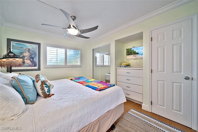 bedroom with ceiling fan, wood finished floors, and crown molding