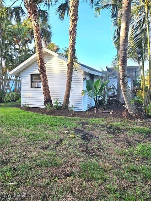 view of side of property with a lawn