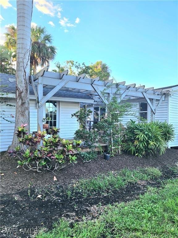 view of side of property with a pergola