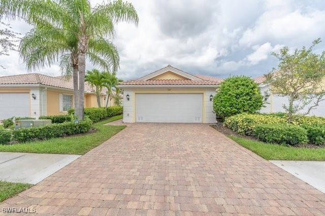 7639 Novara Ct, Naples, FL 34114 - view of front of property featuring stucco siding, a tiled roof, and decorative driveway