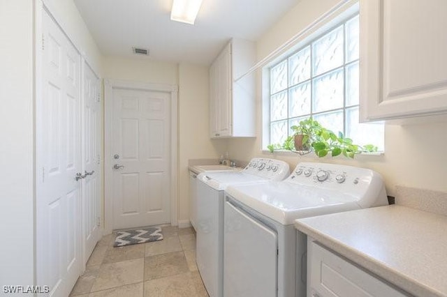 7639 Novara Ct, Naples, FL 34114 - laundry room featuring washing machine and clothes dryer, cabinet space, and visible vents