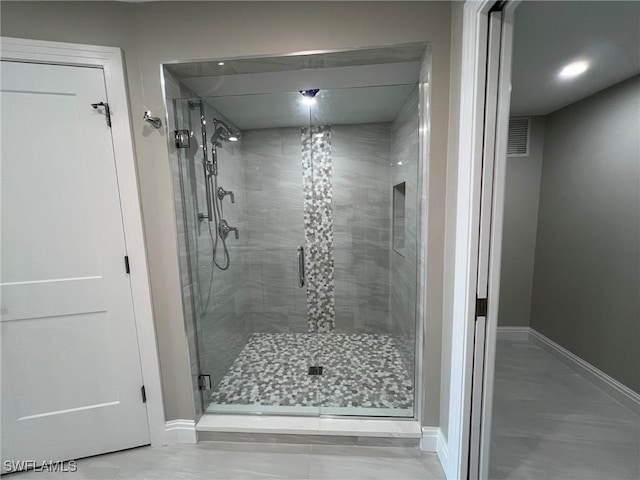 full bathroom featuring visible vents, baseboards, and a shower stall