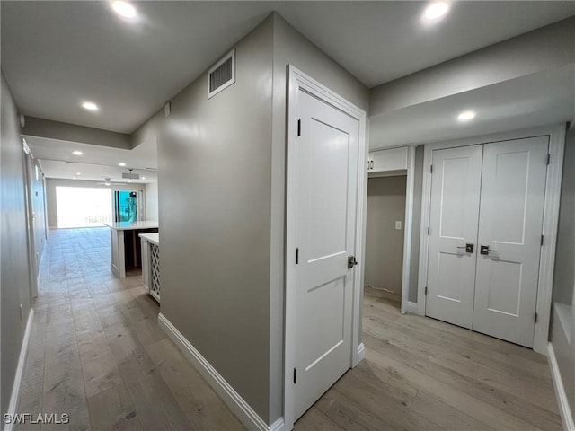 hallway with recessed lighting, visible vents, and light wood-type flooring