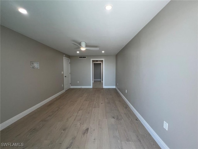 unfurnished room featuring light wood finished floors, visible vents, baseboards, recessed lighting, and a ceiling fan