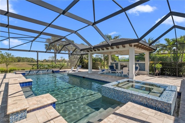 pool featuring a patio area, exterior fireplace, and an outdoor hot tub