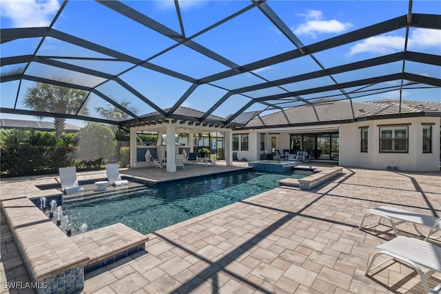 view of pool with glass enclosure, a patio, and a pool with connected hot tub